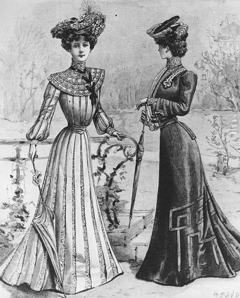 1902:  Two women wearing elegant Edwardian street dresses in a park.  (Photo by Hulton Archive/Getty Images)